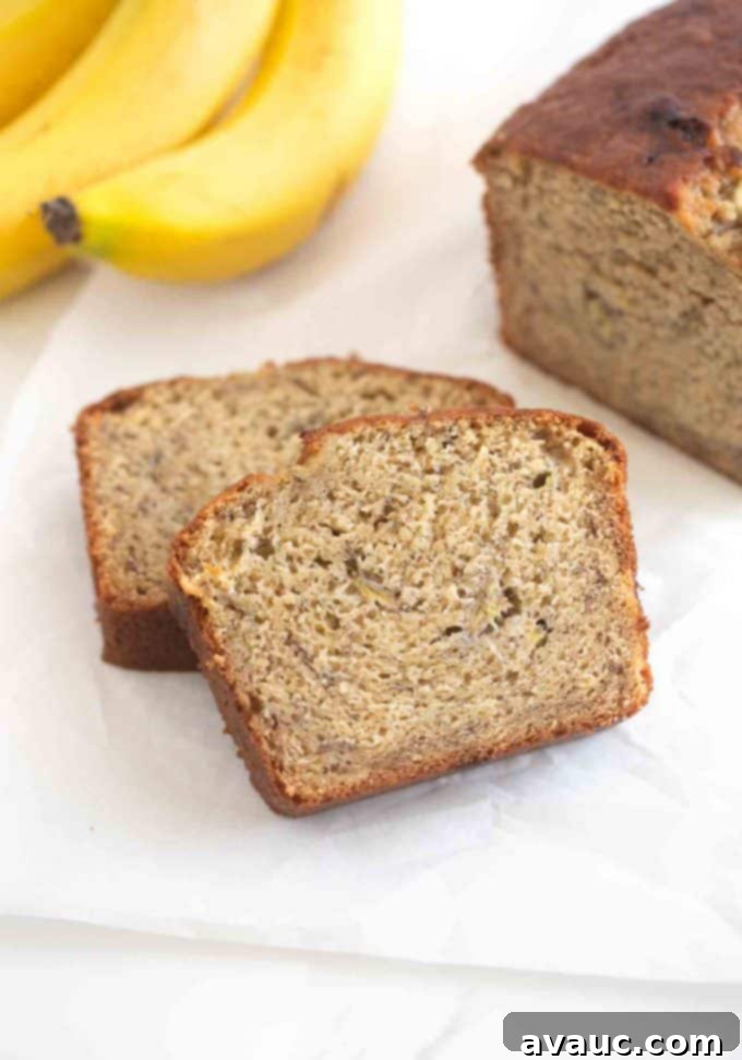 Melt-in-Your-Mouth Banana Bread Perfection 11 Beautifully sliced pieces of moist banana bread on a wooden board, ready to eat.