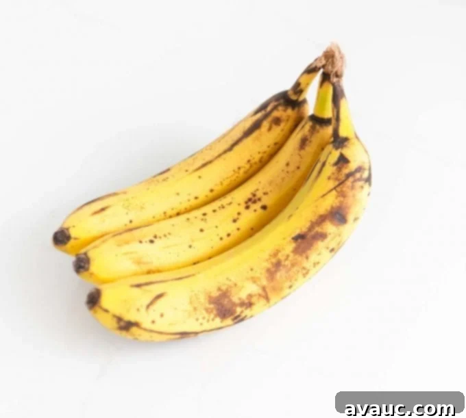 Melt-in-Your-Mouth Banana Bread Perfection 12 Perfectly ripe brown bananas on a kitchen counter, ideal for baking.