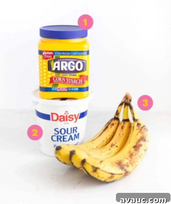 Melt-in-Your-Mouth Banana Bread Perfection 3 Key ingredients for moist banana bread: cornstarch, sour cream, and ripe bananas displayed together.