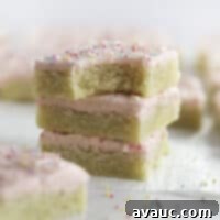 Frosted Sugar Cookie Bars with pink frosting and sprinkles