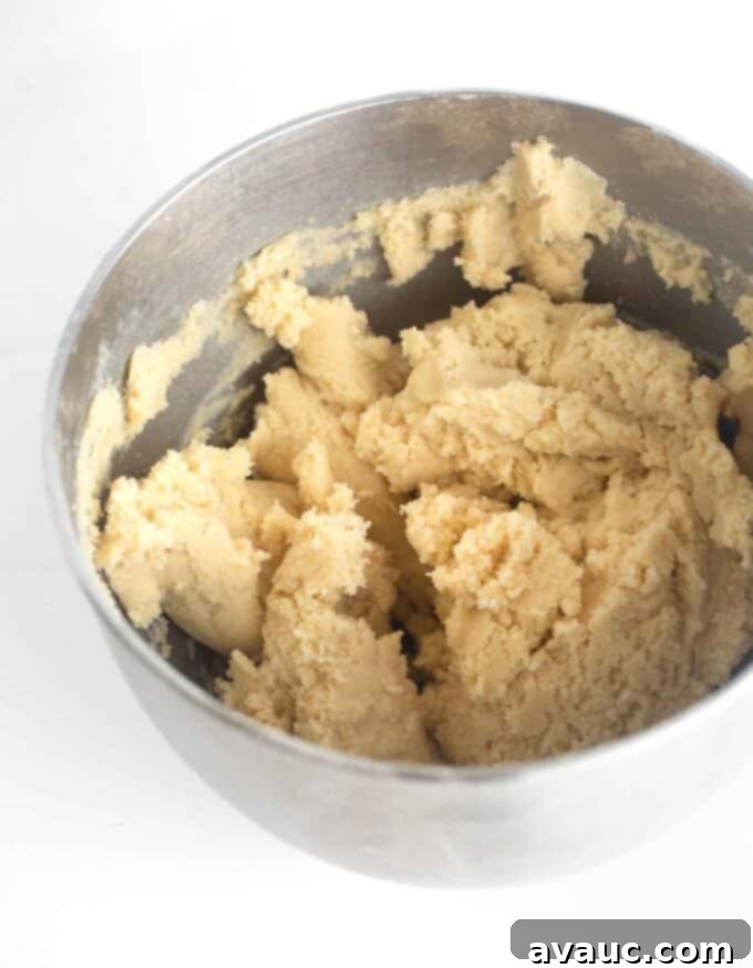 sugar cookie bar dough in bowl, showing its soft yet firm texture