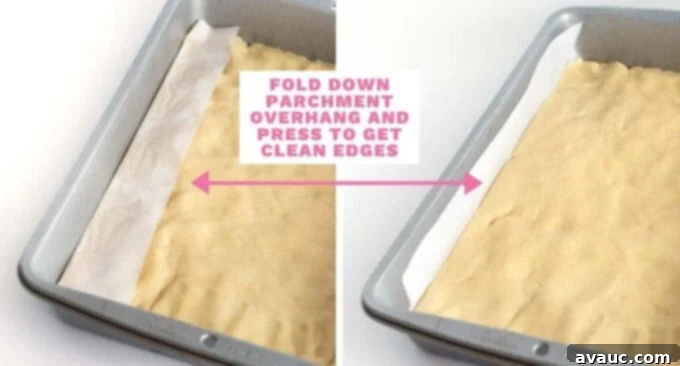 9x13 pan of sugar cookie dough with parchment overhang, demonstrating how to press down for clean edges