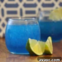 Easy Homemade Blue Slushies 2 Close-up of a homemade Blue Raspberry Slushie with lime slices.