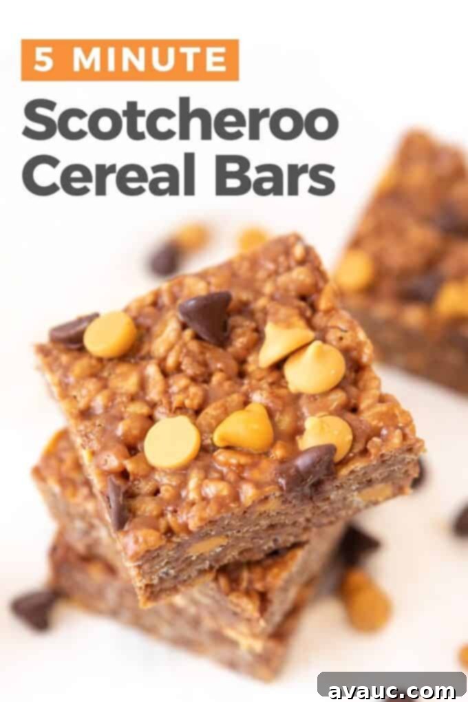Close-up of a perfectly cut Microwave Scotcheroo bar, showing the layers of crispy cereal, peanut butter, and butterscotch, topped with a few extra chips.