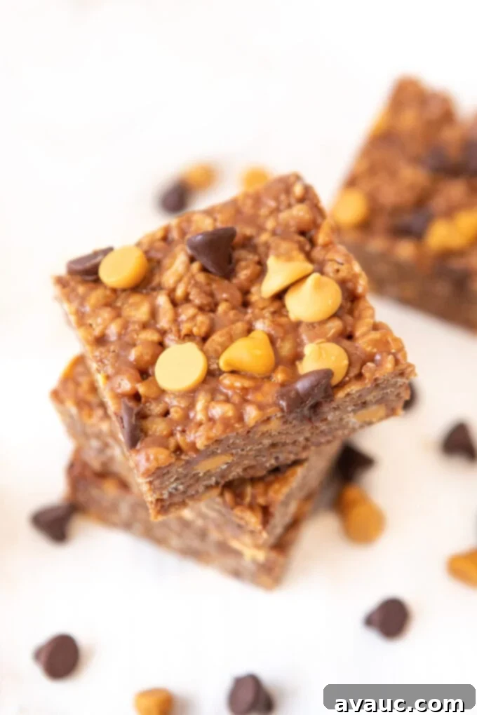 Side view of two Scotcheroo bars, showing the crispy texture and the rich chocolate and butterscotch topping.