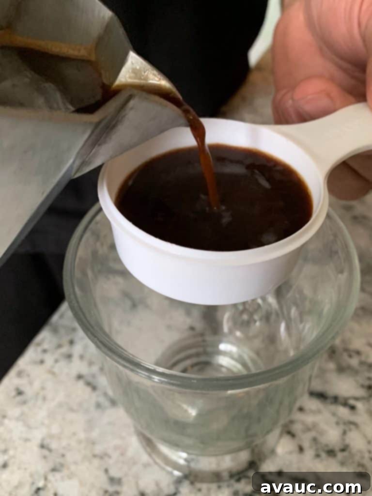 Cocoa Espresso Bliss 7 Pouring brewed coffee into a measuring cup, preparing the mocha base