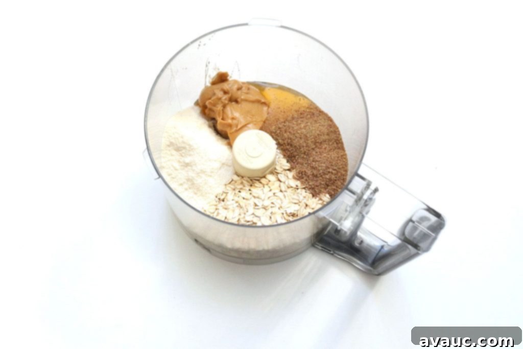 Ingredients for healthy coconut cinnamon gluten-free snacks blended in a food processor.