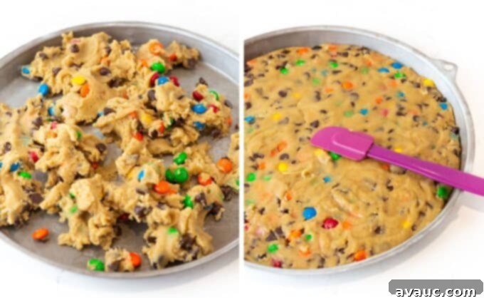 Ultimate Chewy M&M Cookie Cake 6 Pressing M&M cookie cake dough evenly into a round cookie cake pan to create a smooth layer