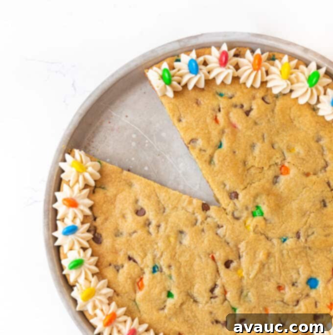 Ultimate Chewy M&M Cookie Cake 9 Beautifully frosted M&M cookie cake with a decorative vanilla buttercream border and colorful M&M's