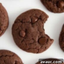 Easy Chocolate Cake Cookies 10 Close-up of a stack of fudgy chocolate cake mix cookies with chocolate chips.