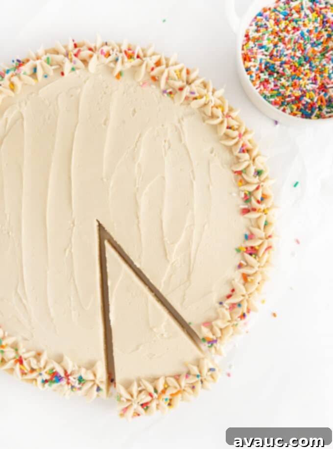 round sugar cookie cake with rainbow sprinkles and slice taken out