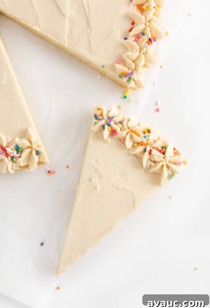slice of sugar cookie cake with buttercream and sprinkles