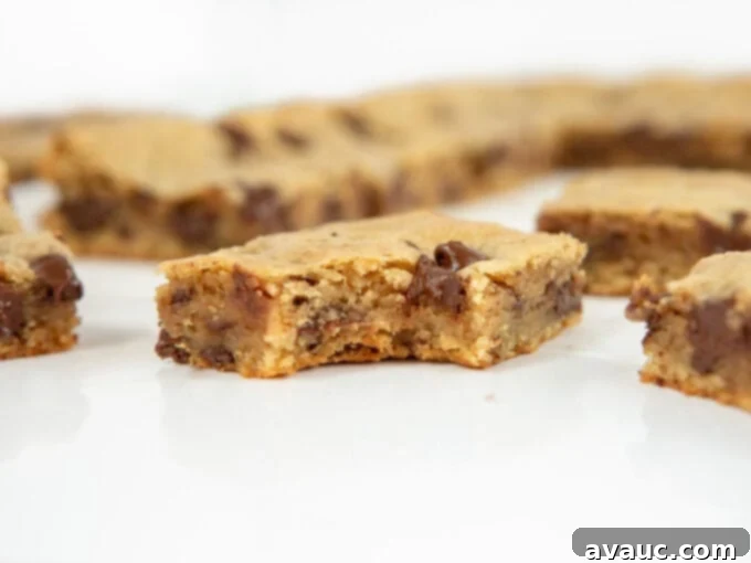 Irresistible Chocolate Chip Squares 6 Several neatly cut chocolate chip cookie bars arranged on a cooling rack.