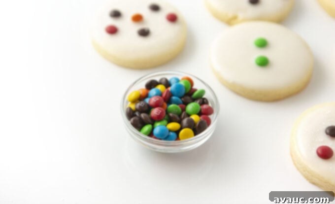Quick and Easy Snowman Cookies 3 a small bowl filled with colorful miniature M&M's, ready for decorating