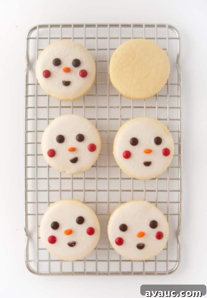 Quick and Easy Snowman Cookies 7 six decorated snowman cookies resting on a wire cooling rack, ready to be enjoyed