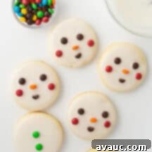 Quick and Easy Snowman Cookies 8 a close-up of a decorated snowman cookie with a white icing base and colorful M&M face details