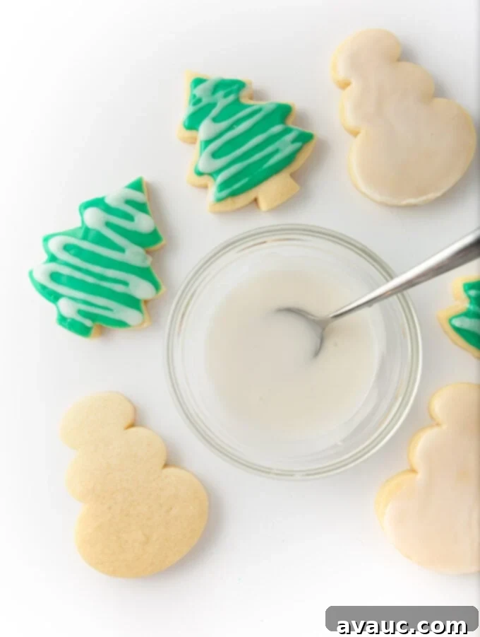 Quick and Easy Sugar Cookie Glaze 2 bowl of white icing and cut out christmas tree sugar cookies with green icing