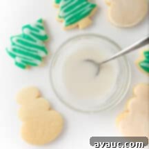 Quick and Easy Sugar Cookie Glaze 11 A beautifully frosted Christmas tree sugar cookie, showcasing the smooth and glossy finish of the simple icing.