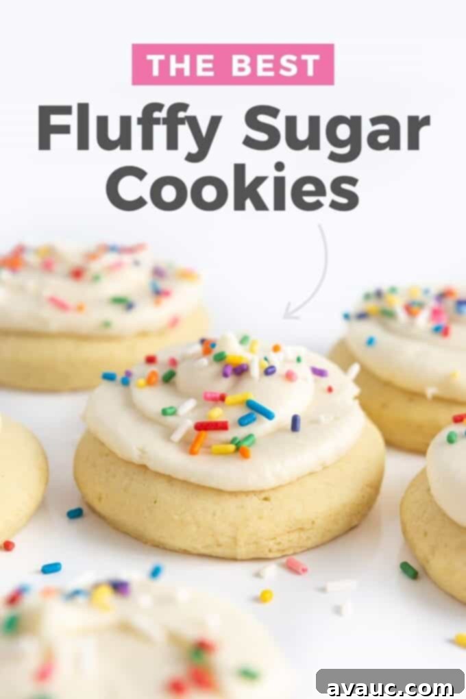 Homemade fluffy sugar cookies topped with creamy buttercream frosting and colorful rainbow sprinkles