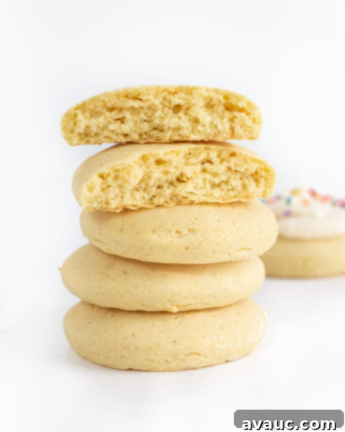Stack of several perfectly baked fluffy sugar cookies with a hint of golden color
