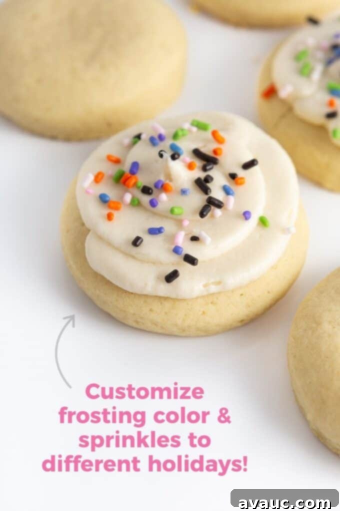 Fluffy sugar cookies with orange and purple Halloween-themed buttercream frosting and festive sprinkles