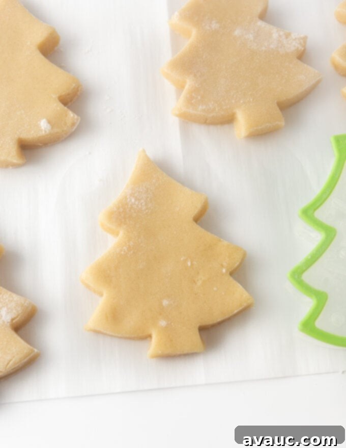 Simple Ways to Decorate Christmas Tree Cookies 3 Neatly cut out sugar cookie dough in the classic Christmas tree shape, perfectly prepared and ready for baking