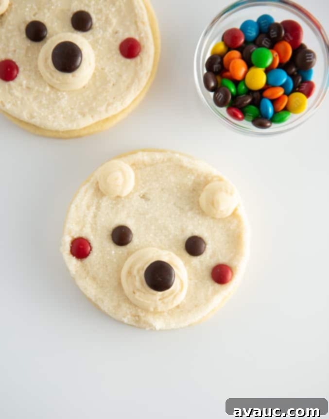 White polar bear cookies with cute M&M faces and frosting details, perfect for winter