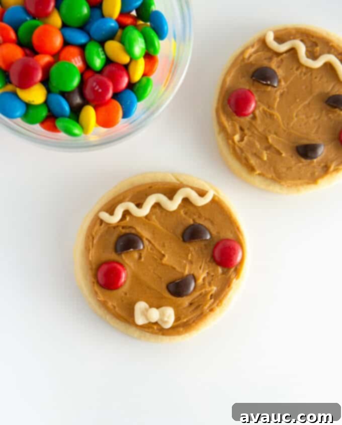Brown gingerbread man cookies with cheerful M&M faces and white frosting details