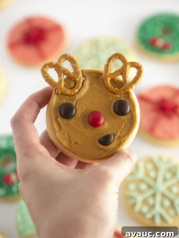 Easy Rudolph Cookies 3 Two decorated Rudolph cookies with M&M eyes and nose, and pretzel antlers.