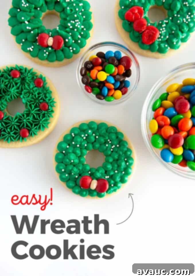 Green buttercream wreath sugar cookies with red M&M candy creating a bow, arranged beautifully
