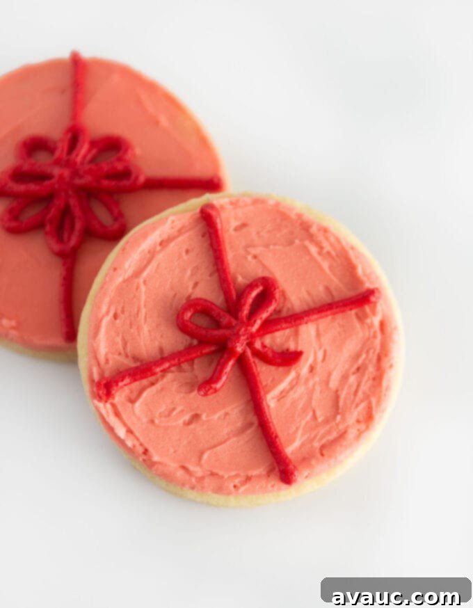 pink present sugar cookie with a piped red bow design