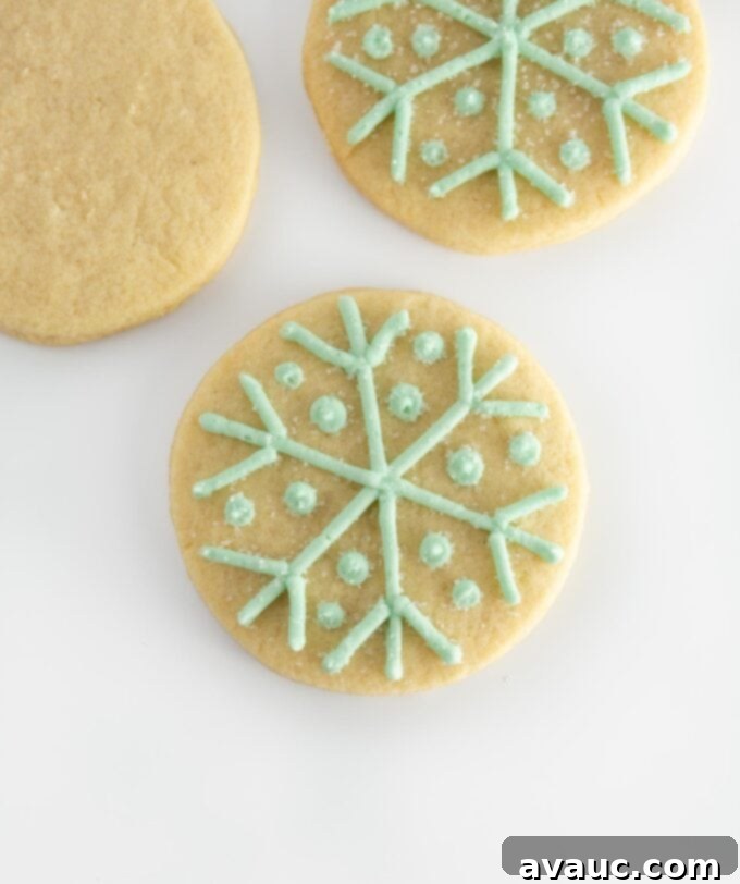circle sugar cookie with a detailed blue snowflake piped on top