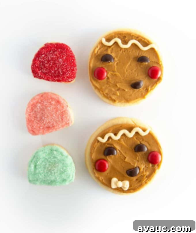 Round Gingerbread Man Sugar Cookies 7 Collection of brown gingerbread man face cookies with colorful gumdrop cookies on a white surface.