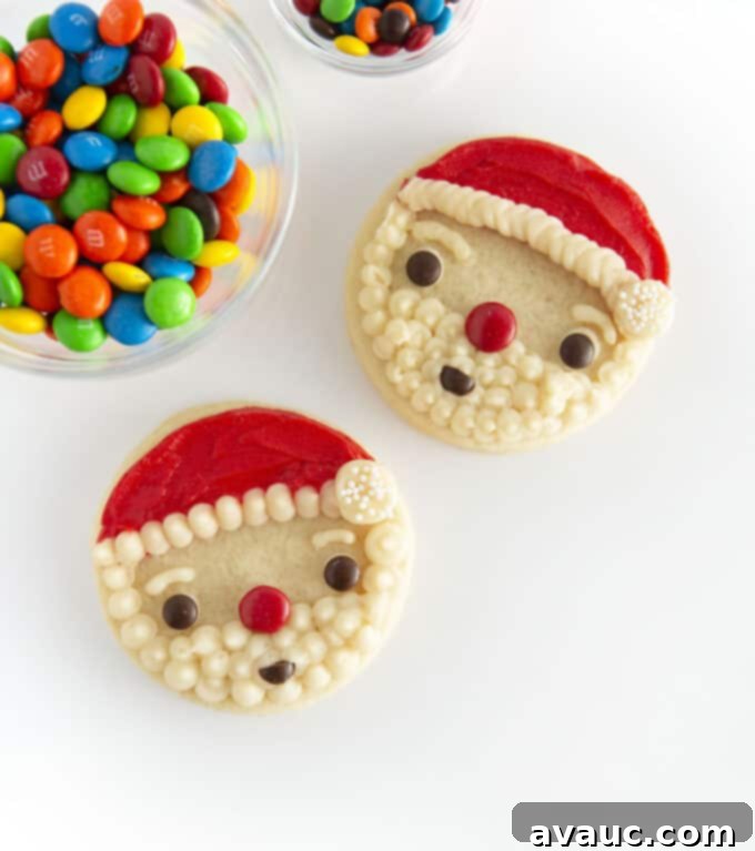 Finished circle Santa face sugar cookies decorated with M&M candy on a platter