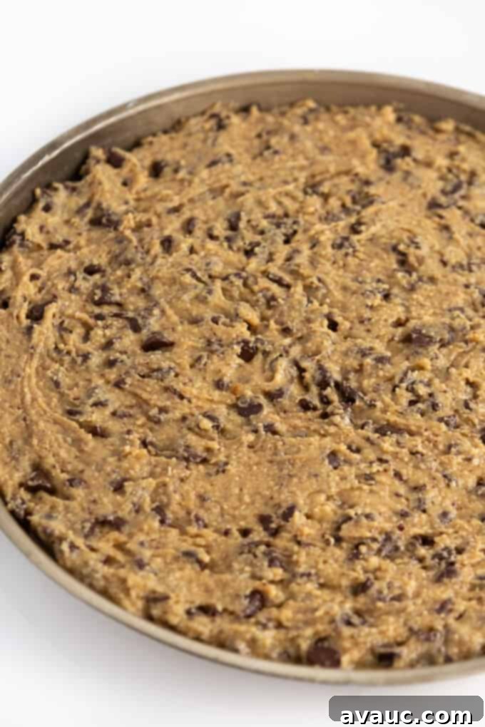 Unbelievably Chewy Gluten-Free Cookie Cake 9 pan of unbaked chocolate chip cookie cake dough