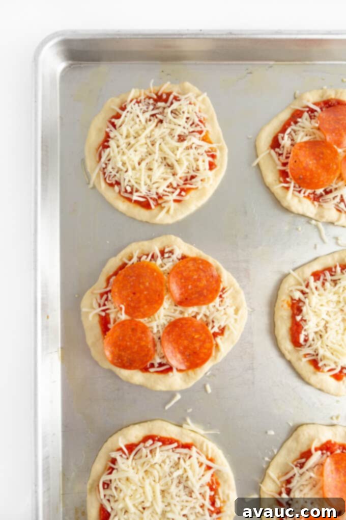 Easy Mini Pizzas for Little Chefs 3 mini pizza dough with sauce, cheese and pepperoni toppings