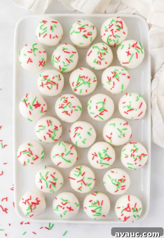 Gourmet Sugar Cookie Truffles 10 tray of finished white chocolate sugar cookie truffles with red and green sprinkles, ready to be enjoyed