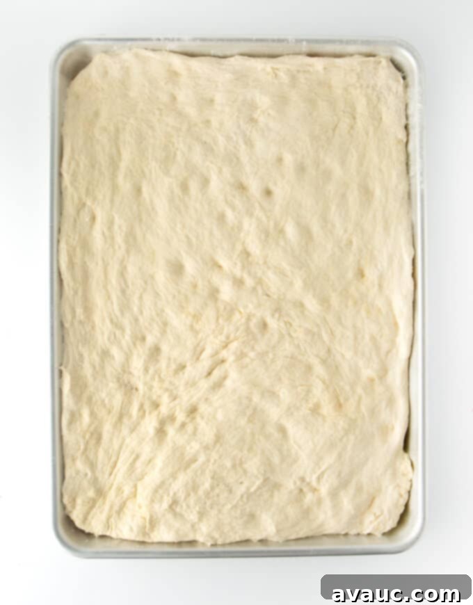 Pillowy One-Pan Pizza 8 Dough pressed into a sheet pan