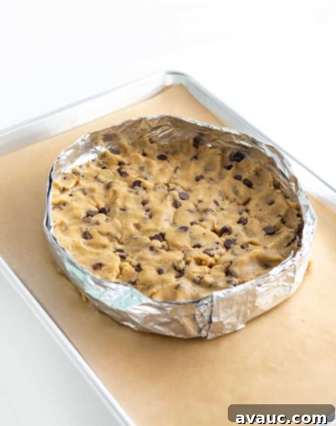 DIY cookie cake pan made from aluminum foil on a baking sheet