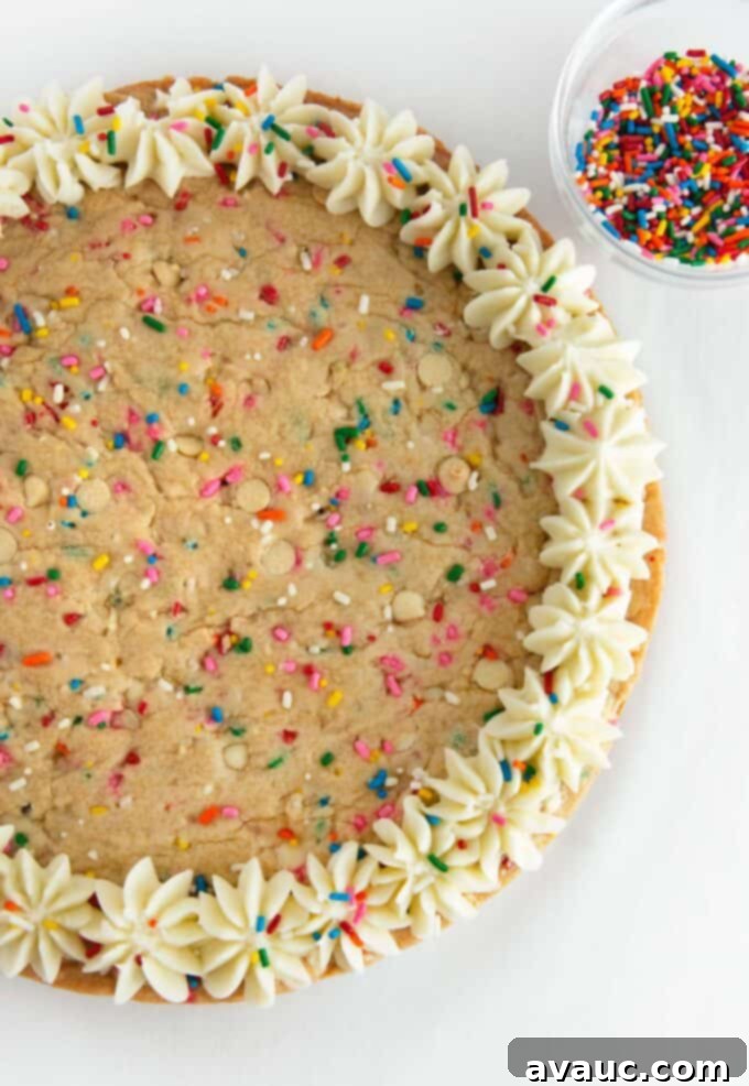 Vibrant Chewy Funfetti Cookie Cake 11 Decorating a funfetti cookie cake with vanilla buttercream frosting and sprinkles.