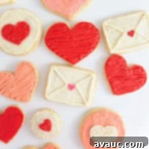 3 Quick Valentine Cookie Decorating Hacks 11 A platter of beautifully decorated Valentine's Day sugar cookies in various shapes and colors.