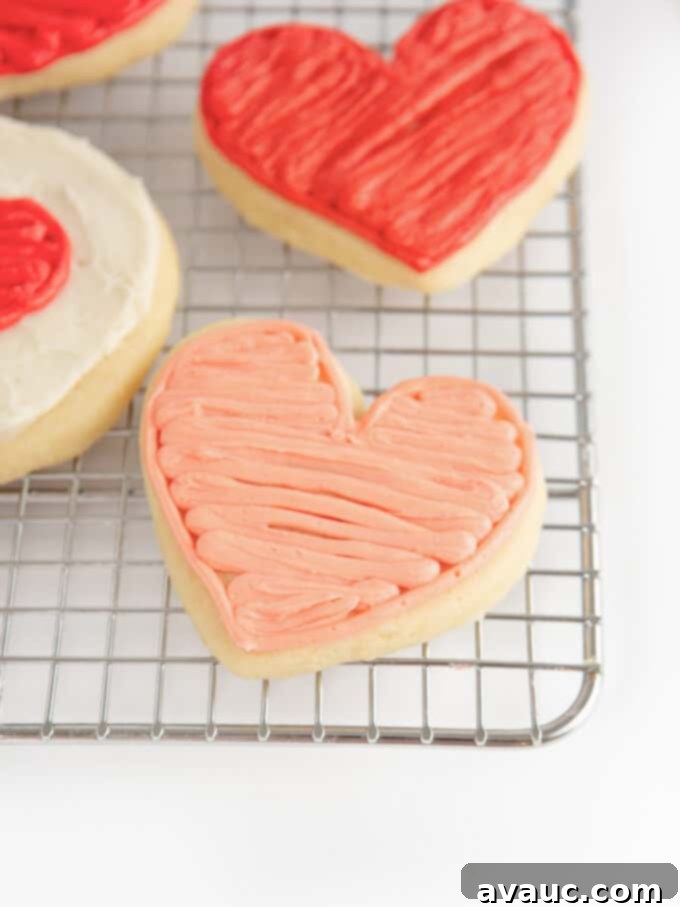3 Quick Valentine Cookie Decorating Hacks 3 A perfectly frosted pink and red heart-shaped sugar cookie, ready for Valentine's Day.