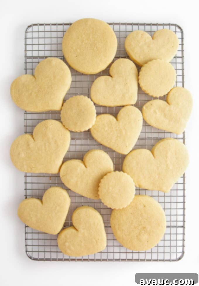 3 Quick Valentine Cookie Decorating Hacks 6 Freshly baked heart-shaped Valentine sugar cookies on a cooling rack.
