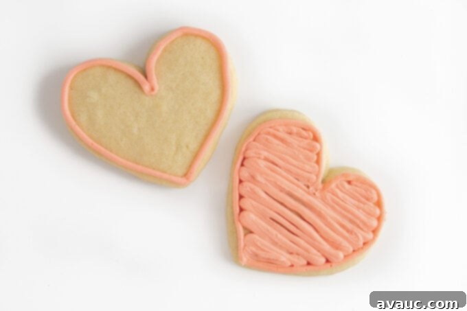 3 Quick Valentine Cookie Decorating Hacks 8 A collection of beautifully decorated pink heart-shaped sugar cookies with sprinkles.