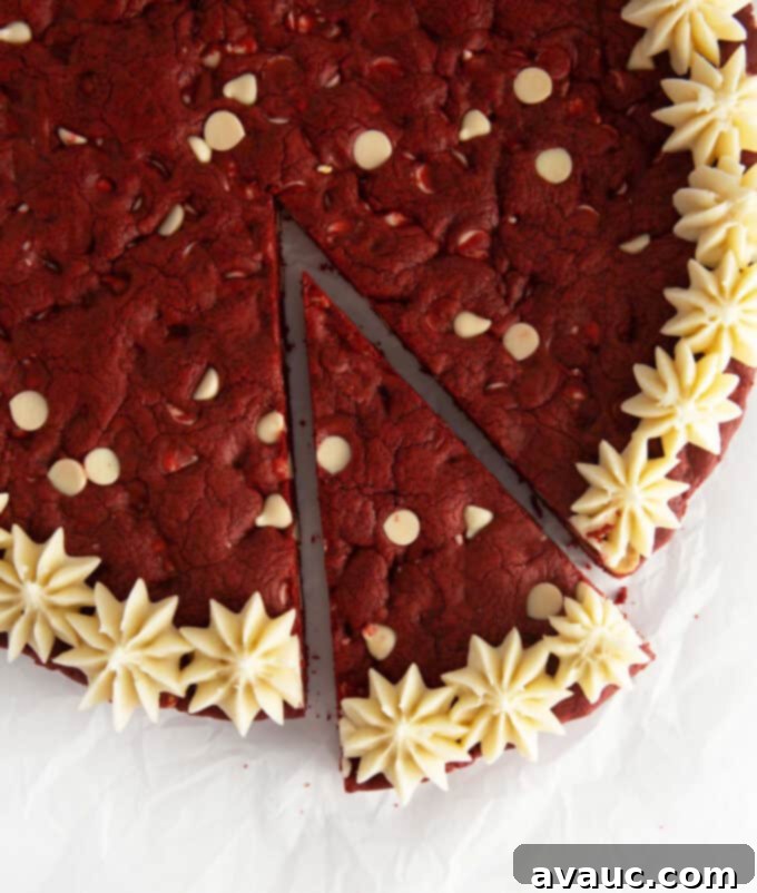 Decadent Red Velvet Cookie Cake 11 A slice of red velvet cookie cake on a plate, showing its interior texture and frosting.