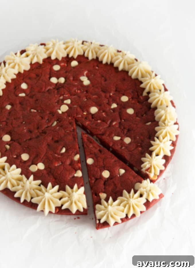 Decadent Red Velvet Cookie Cake 12 Close-up of a decorated red velvet cookie cake with a cream cheese frosting border.