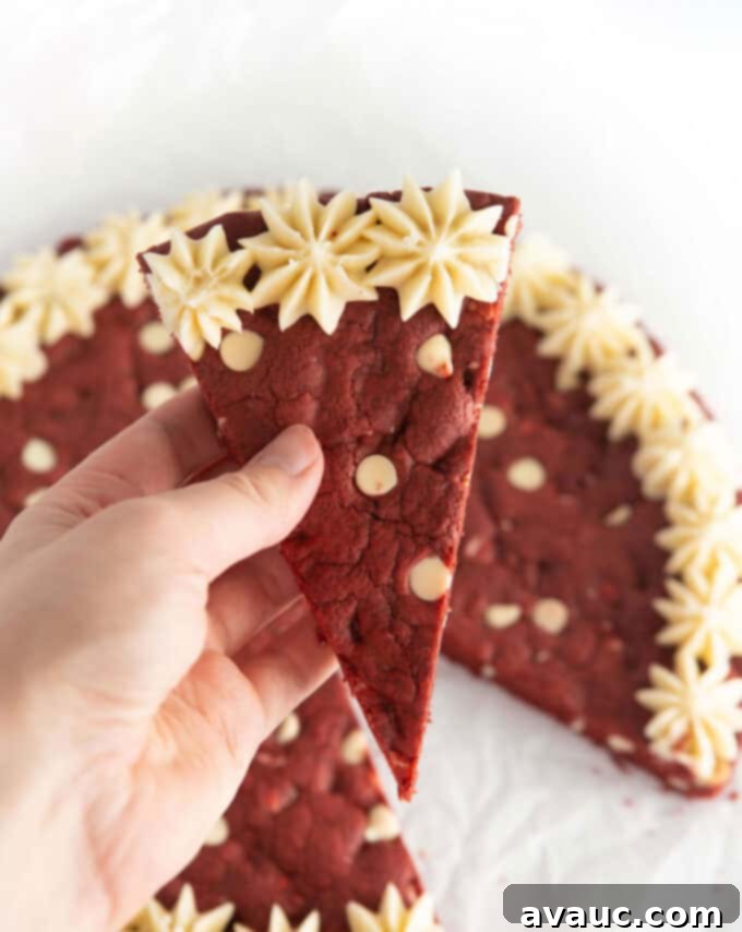 Decadent Red Velvet Cookie Cake 4 Close-up of the edge of the red velvet cookie cake, showing its chewy texture and white chocolate chips.
