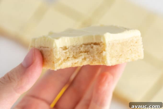 An inviting stack of frosted lemon sugar cookie bars, perfect for sharing or enjoying as a refreshing treat.