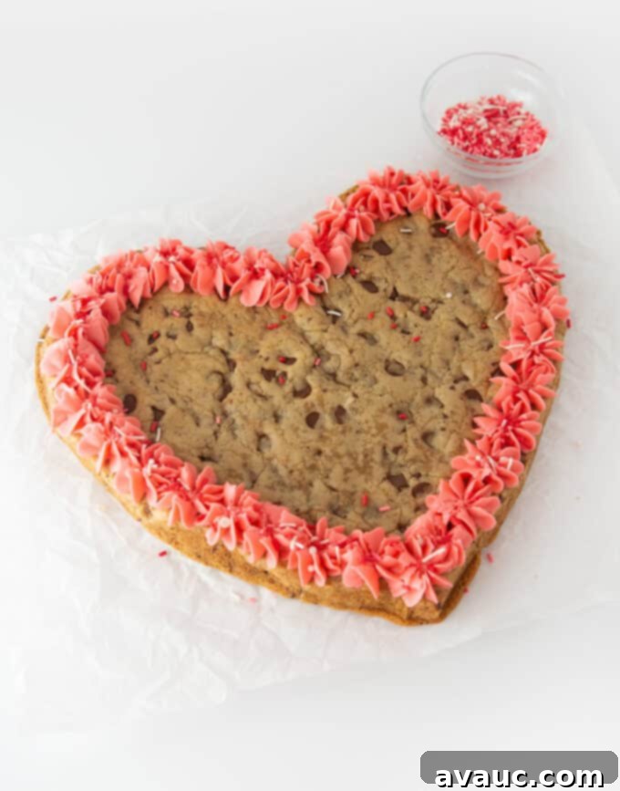 Valentines heart cookie cake with pink frosting and sprinkles