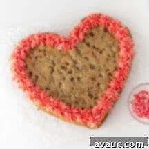 Heart-shaped cookie cake with pink frosting